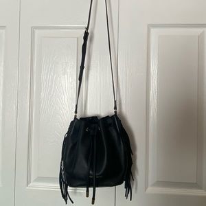 Black leather bucket crossbody bag with fringe